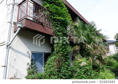 Abandoned apartment eroded by plants 92882684