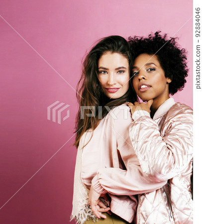 different nation girls with diversuty in skin, hair. Asian, scandinavian, african american cheerful emotional posing on pink background, woman day celebration, lifestyle people concept closeup different nation girls with diversuty in skin, hair. Asian, scandinavian, african american cheerful emotional posing on pink background, woman day celebration, lifestyle people concept closeup 92884046
