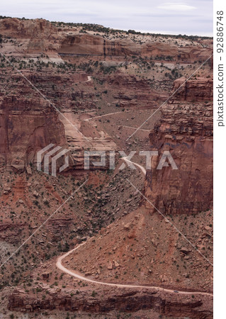 Dirt route in Desert Canyon with Scenic American Landscape and Red Rock Mountains. 92886748