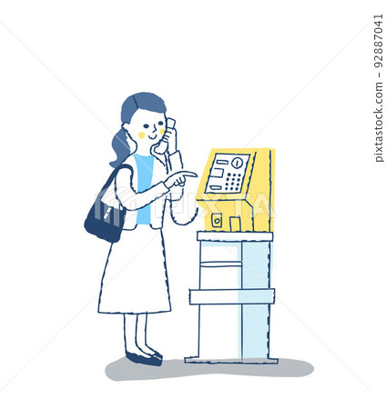 Woman making a call on a public phone 92887041