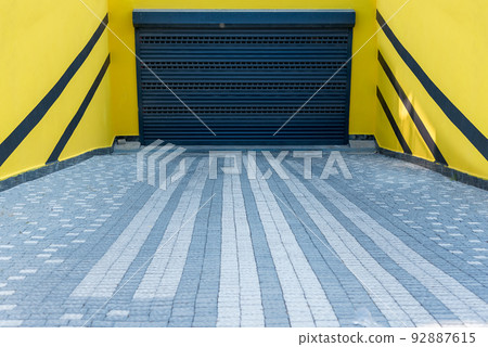Entrance to the underground parking from the street in a residential building. 92887615