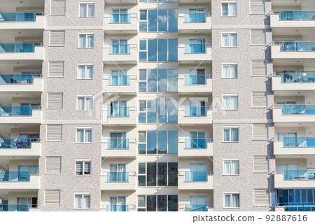 Front view of the windows of a residential apartment building. Front view of the windows of a residential apartment building. 92887616