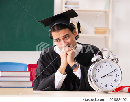 Graduate student in front of green board Graduate student in front of green board 92888402