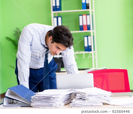 Frustrated businessman stressed from excessive work Frustrated businessman stressed from excessive work 92888446