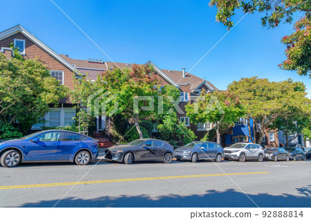 Parked vehicles on the side of the road at the front of the houses at San Francisco, California Parked vehicles on the side of the road at the front of the houses at San Francisco, California 92888814