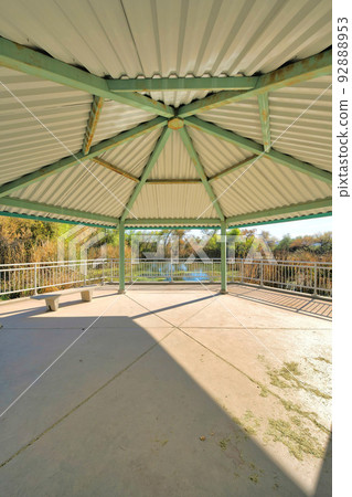 Under the roof of a large gazebo with seat at Sweetwater Wetlands- Tucson, Arizona 92888953