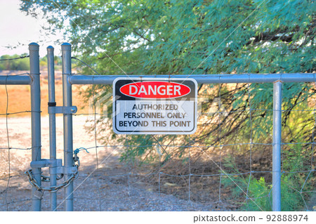 Metal wire gate with danger sign at Sweetwater Wetlands in Tucson, Arizona 92888974