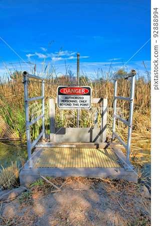 Danger Authorized Personnel Only Beyond This Point sign hanging at Sweetwater Wetlands, Tucson, AZ 92888994