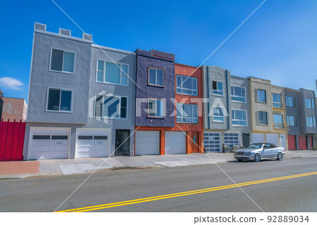 Townhouses with attached two-car garages beside the road in San Francisco, CA 92889034