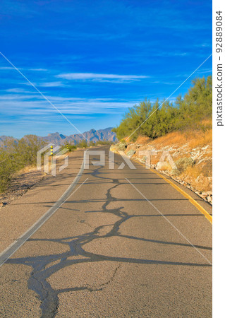 Asphalt road with cracks on mountain slope in Tucson, Arizona 92889084