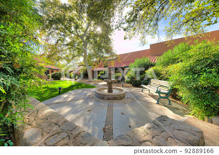 Water fountain and bench surrounded by the italianate houses in a subdivision at Tucson, Arizona Water fountain and bench surrounded by the italianate houses in a subdivision at Tucson, Arizona 92889166