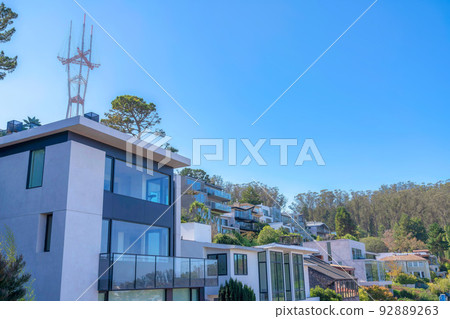 Large residential buildings near the trees and Sutro Tower in San Francisco, CA 92889263