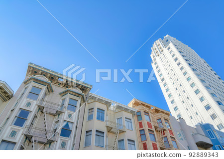 Low-rise apartment buildings beside the high-rise building in a low angle view at San Francisco, CA Low-rise apartment buildings beside the high-rise building in a low angle view at San Francisco, CA 92889343