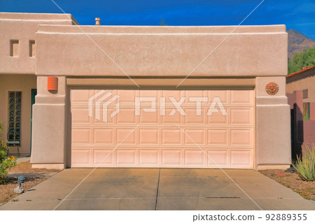 Garage exterior of a painted cream mediterranean home at Tucson, Arizona 92889355