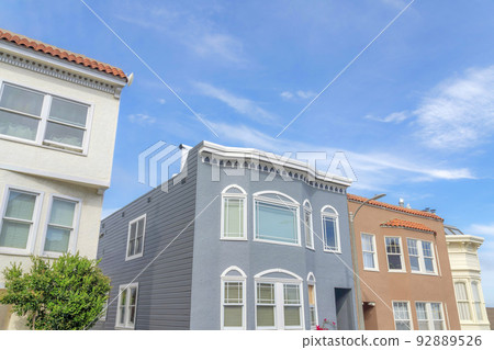 Suburban houses with pastel colors exterior in a low angle view in San Francisco, California 92889526