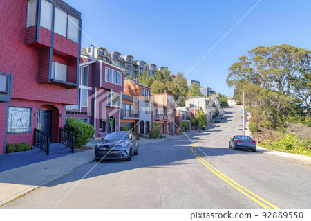 Road with double yellow lane near the row of suburban houses in San Francisco, California 92889550