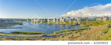 Residential houses surrounding the Oquirrh Lake at Daybreak, South Jordan, Utah Residential houses surrounding the Oquirrh Lake at Daybreak, South Jordan, Utah 92889603