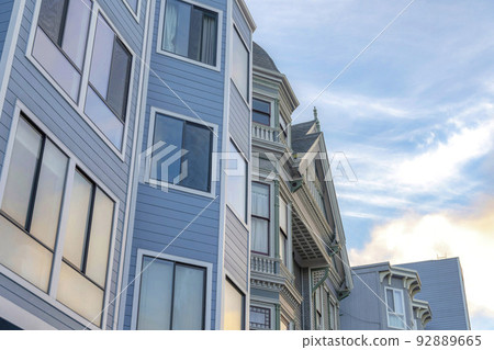 Victorian townhouses with reflective glass windows in San Francisco, California Victorian townhouses with reflective glass windows in San Francisco, California 92889665