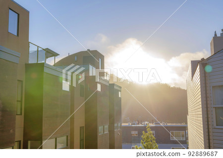 Modern townhouses across the traditional house against the sunset sky at San Francisco, CA Modern townhouses across the traditional house against the sunset sky at San Francisco, CA 92889687