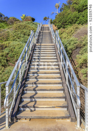 Outdoor stairs with wooden steps and metal railings at San Clemente, California Outdoor stairs with wooden steps and metal railings at San Clemente, California 92889746