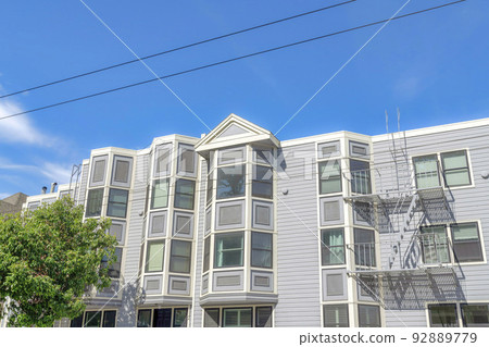 Apartment buildings exterior with gray vinyl lap sidings and emergency stairs in San Francisco, CA 92889779