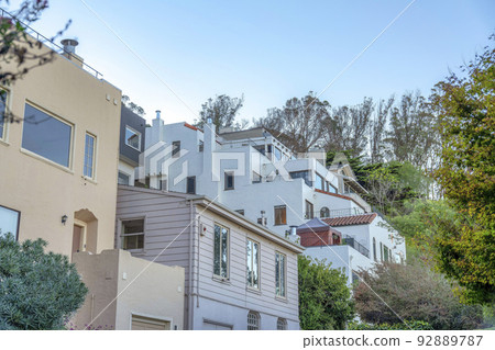 Residential buildings in San Francisco, California near the trees at the back Residential buildings in San Francisco, California near the trees at the back 92889787