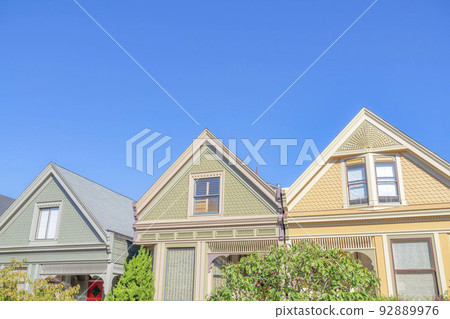 Row of houses with gable roofs and decorative shingles in San Francisco, California Row of houses with gable roofs and decorative shingles in San Francisco, California 92889976