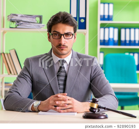 Young handsome lawyer working in the office 92890193