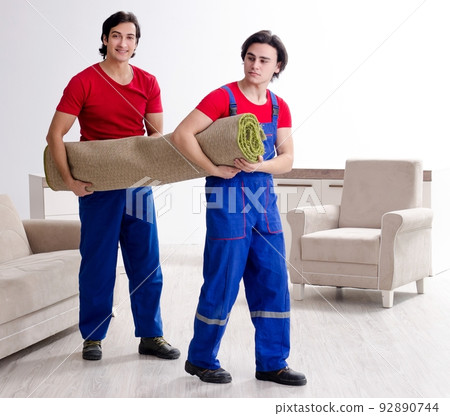 Two young contractor employees moving personal belongings Two young contractor employees moving personal belongings 92890744