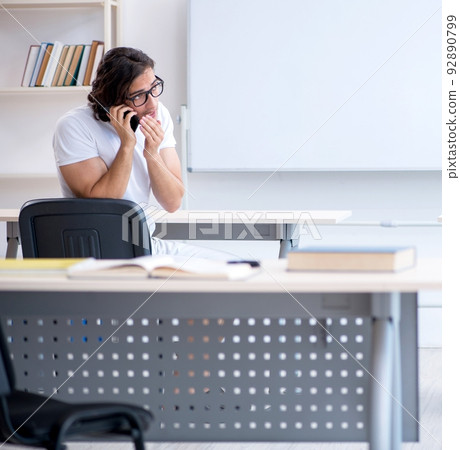 Young male student in front of whiteboard Young male student in front of whiteboard 92890799
