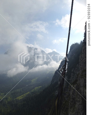 Climber at Seebenklettersteig via ferrata, Tyrol, Austria in summertime Climber at Seebenklettersteig via ferrata, Tyrol, Austria in summertime 92891034