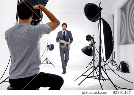 Working that studio. Shot of a photographer working in his studio. 92891307