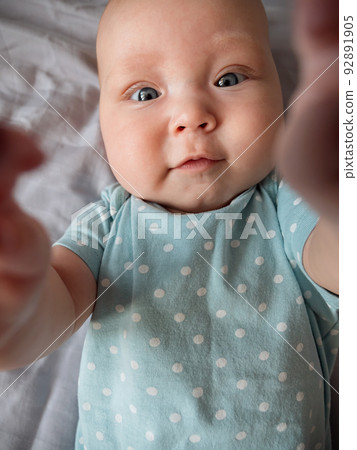 Enthusiastic child holds phone talking with grandparents through the camera 92891905