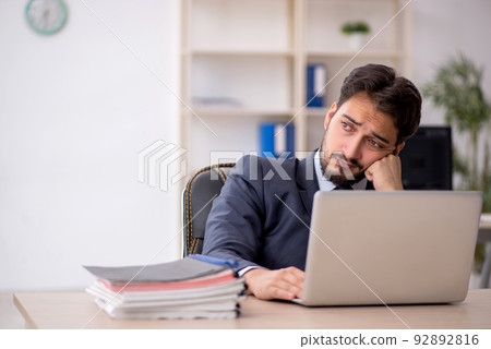 Young male employee working in the office Young male employee working in the office 92892816