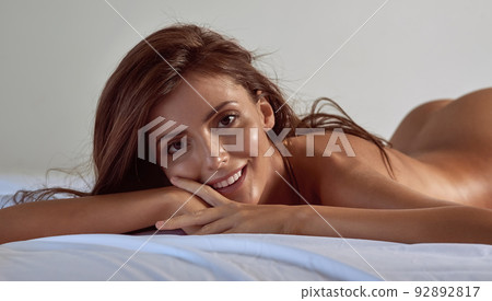 Shes the type of girl you dream about. Shot of a beautiful young woman posing nude in her bedroom. Shes the type of girl you dream about. Shot of a beautiful young woman posing nude in her bedroom. 92892817