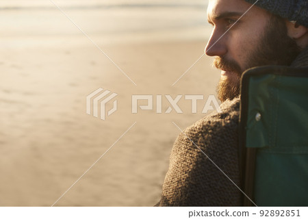 Taking a break. SIde view of an attractive man looking into the distance. Taking a break. SIde view of an attractive man looking into the distance. 92892851