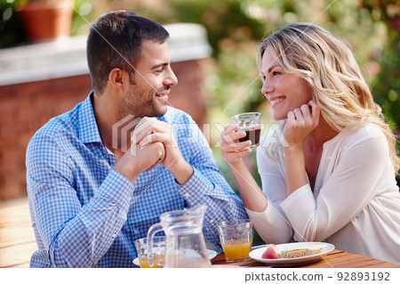 What a perfect morning. Shot of a young couple enjoying breakfast outdoors. What a perfect morning. Shot of a young couple enjoying breakfast outdoors. 92893192