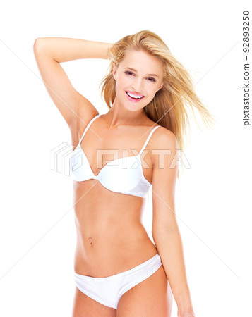 Learn to love your body. Joyful young woman in her underwear while isolated on white. 92893250