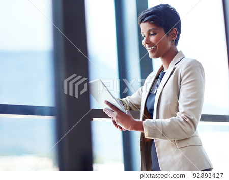4g technology gives her the corporate advantage. Shot of a young businesswoman using a digital tablet in an office. 92893427