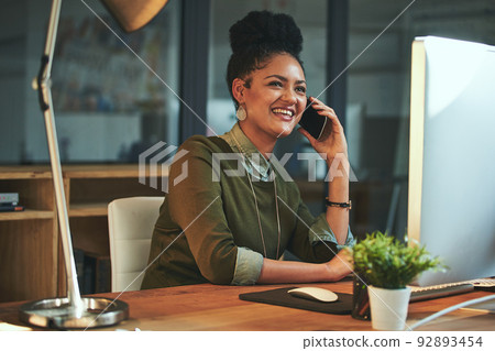 Just calling to let you know Ill be late. Shot of an attractive young woman using her cellphone in the office. Just calling to let you know Ill be late. Shot of an attractive young woman using her cellphone in the office. 92893454