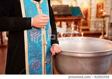 priest with orthodox cross on baptism in Orthodox Church. priest with orthodox cross on baptism in Orthodox Church. 92893456