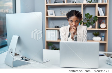Young confident, focused and thinking businesswoman sitting alone in an office and browsing the internet on a computer. Ambitious creative professional planning and thinking of ideas at a desk Young confident, focused and thinking businesswoman sitting alone in an office and browsing the internet on a computer. Ambitious creative professional planning and thinking of ideas at a desk 92893475
