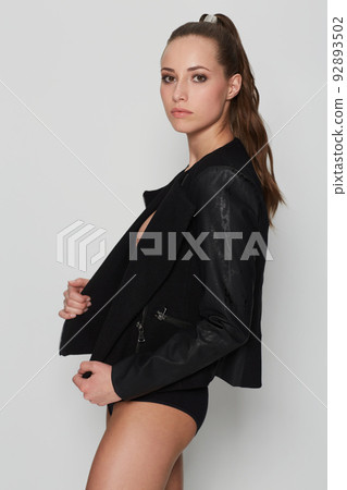 Lingerie with an attitude. Studio portrait of a young woman wearing a coat and lingerie. 92893502