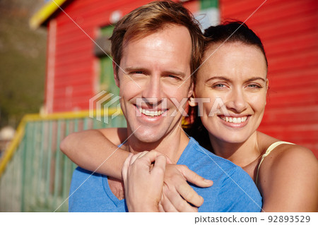 Our beach house. Cropped shot of a couple on a beachside holiday. 92893529