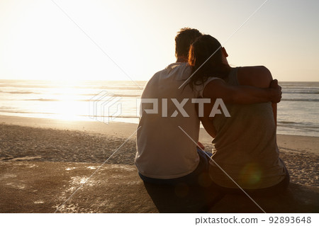 Life is perfect with you by my side. Silhouette of a couple sitting beside each other at the beach. Life is perfect with you by my side. Silhouette of a couple sitting beside each other at the beach. 92893648