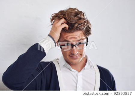 Im confused.... A young man with messy hair looking perplexed. 92893837