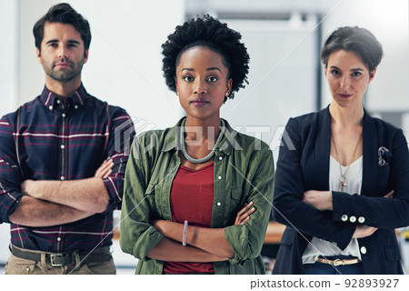 We take pride in our teams work ethic. Portrait of a group of businesspeople standing with their arms folded in a modern office. 92893927