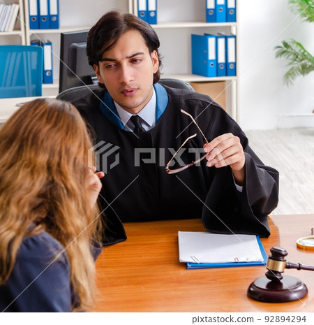 Young woman visiting male lawyer 92894294