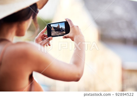 Capturing all the beauty of this wonderful city. Rearview shot of an unrecognizable young woman taking photos in a foreign city. Capturing all the beauty of this wonderful city. Rearview shot of an unrecognizable young woman taking photos in a foreign city. 92894522