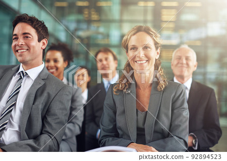 Its a positive presentation. Cropped shot of a group of businesspeople sitting in a presentation. Its a positive presentation. Cropped shot of a group of businesspeople sitting in a presentation. 92894523